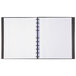 A black Blueline MiracleBind notebook with white lined pages.