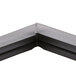 A black corner piece with a crack in the corner.