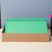 A box with a green Universal Office leatherette report cover with clear cover and prong fasteners.