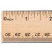 A close-up of a Universal flat wood ruler with double metal edge and numbers.