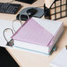 A white Universal economy view binder with a pink cover on top of a stack of papers.