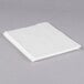 A white sheet of paper in a clear sheet protector on a gray surface.