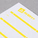 A sheet of white paper with rectangular white and yellow labels on it.