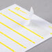 A white rectangular Avery file folder label with a yellow stripe on it.