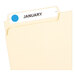 A file folder with a light blue Avery label on it.