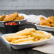 A Huhtamaki Chinet white rectangular paper food tray with french fries and chicken strips.