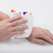 A person using a Medique instant hot pack to treat their hand.
