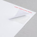 A white paper with a Universal white label with a curled corner.