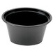 A black Pactiv plastic oval souffle container with a lid.