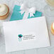 A package of white Avery Mailing Address Labels with blue and white packaging next to cupcakes.