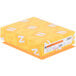 A yellow rectangular box of Astrobrights Cosmic Orange cardstock with white and yellow labels.