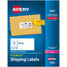 A blue box with white Avery shipping labels.