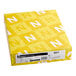 A yellow package of white Neenah Vellum Paper Cover Stock with white and yellow letters on it.