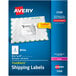 A blue box of white rectangular Avery shipping labels with a yellow border.