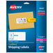 A package with a blue and yellow rectangle shipping label from Avery with white ink.