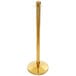 A close up of a gold Lancaster Table & Seating rope-style crowd control stanchion.