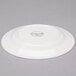 A white Reserve by Libbey round porcelain plate with a small white logo.