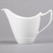 A white Royal Rideau porcelain creamer with a handle.