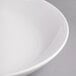 A close-up of a white Reserve by Libbey Silk porcelain serving bowl with a rim.