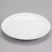 A white Reserve by Libbey Royal Rideau coupe plate on a gray surface.