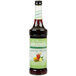 A bottle of Monin Lemon Tea concentrate with a green label.