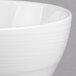 A close up of a white Royal Rideau Silk porcelain bouillon bowl with a rim.