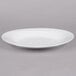 A white narrow rim oval porcelain platter on a white background.