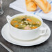 A bowl of soup on a white Royal Rideau porcelain saucer.