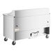 A white True refrigerated sandwich prep table with stainless steel top and wheels.