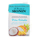 A blue and white carton of Monin Pina Colada Fruit Smoothie Mix with a close up of pineapple and coconut.