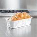 A loaf of bread in a D&W aluminum foil container.