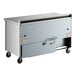 A True worktop refrigerator with a stainless steel counter top and wheels.