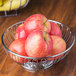 An American Metalcraft stainless steel basket filled with red apples.