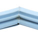 A close up of a Delfield magnetic blue corner piece.