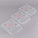 A group of three clear plastic Edlund scale covers with holes in them.