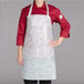 A woman wearing a Chicopee Chix white food service apron.