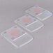 Three clear plastic Edlund ClearShield scale covers with red writing.