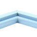 A close-up of a blue corner piece with a small hole in it.