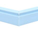A close-up of a blue and green corner of a white magnetic drawer gasket.