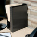 A black Avery Heavy-Duty View Binder on a desk.