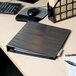 An Avery black heavy-duty view binder sitting on a desk.