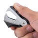 A hand using a black Swingline Deluxe Jaw-Style Staple Remover to remove a staple.