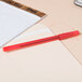A red Bic round stic pen on a pad