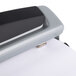 A white and silver Swingline Precision Pro 2-to-3 hole punch.