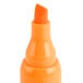 A close-up of a Universal fluorescent orange chisel tip highlighter.