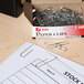 A box of Acco silver paper clips on a table.