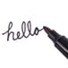 The open bullet tip of a black Universal permanent marker.