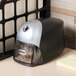 A black and graphite Bostitch electric pencil sharpener on a desk.