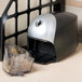 A black and silver Bostitch electric pencil sharpener next to a plastic container.