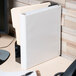 A white Avery Heavy-Duty View Binder on a desk.